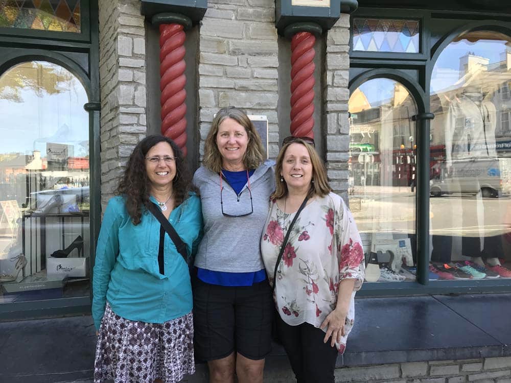 3 women posing outside store front