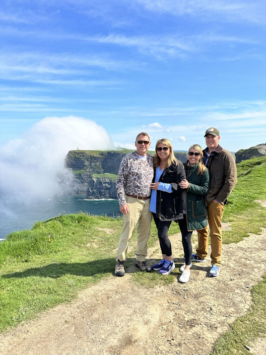 kerry tour guides - group posing close to cloudy cliffs